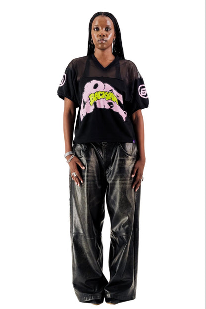 Person wearing a black outfit with graphic designs on a white background